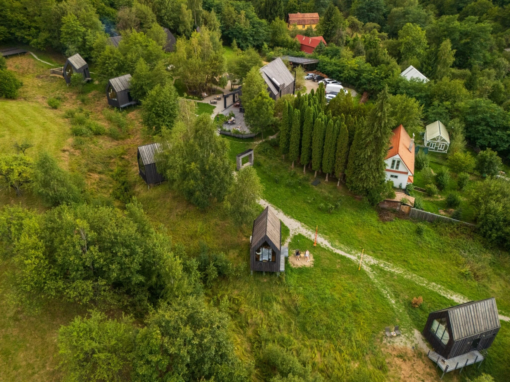 Privire de sus asupra satului Portal, cu alei, bungalouri și pădure